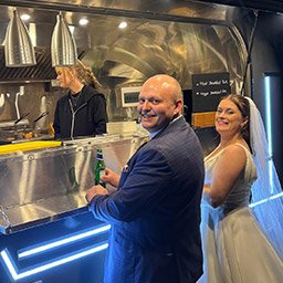 Airstream Catering Trailer at a Dorset Wedding Bride and groom enjoying food from the Crab Apple Airstream catering trailer at a Dorset wedding