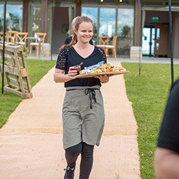 Dorset Catering Team Serving a Sharing Board Crab Apple Catering team member serving a sharing board at an outdoor event in Dorset